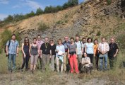 Members of the Subcommission on Silurian Stratigraphy in the Kosov near Beroun quarry. The Upper Silurian limestones of the Kopanina Formation in the background.ence kopaninského souvrství svrchního siluru.